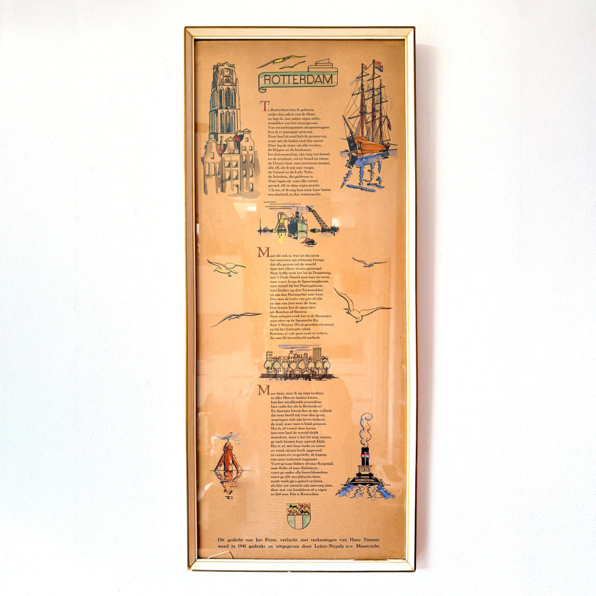Dutch vintage framed Rotterdam poem print with illustrations by Hans Timmer, warm brown paper and cream and gold-toned frame, bearing a 1941 publication credit. 

