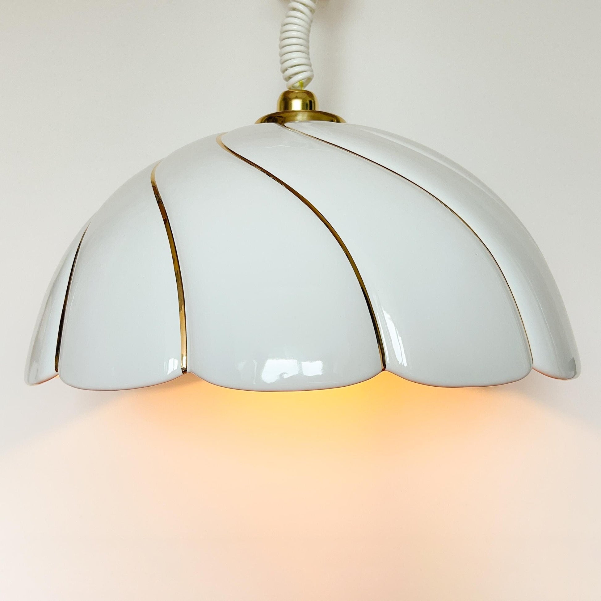 Vintage sculptural ceramic pendant lamp attributed to Tommaso Barbi with white glazed shade and gold brushstrokes.