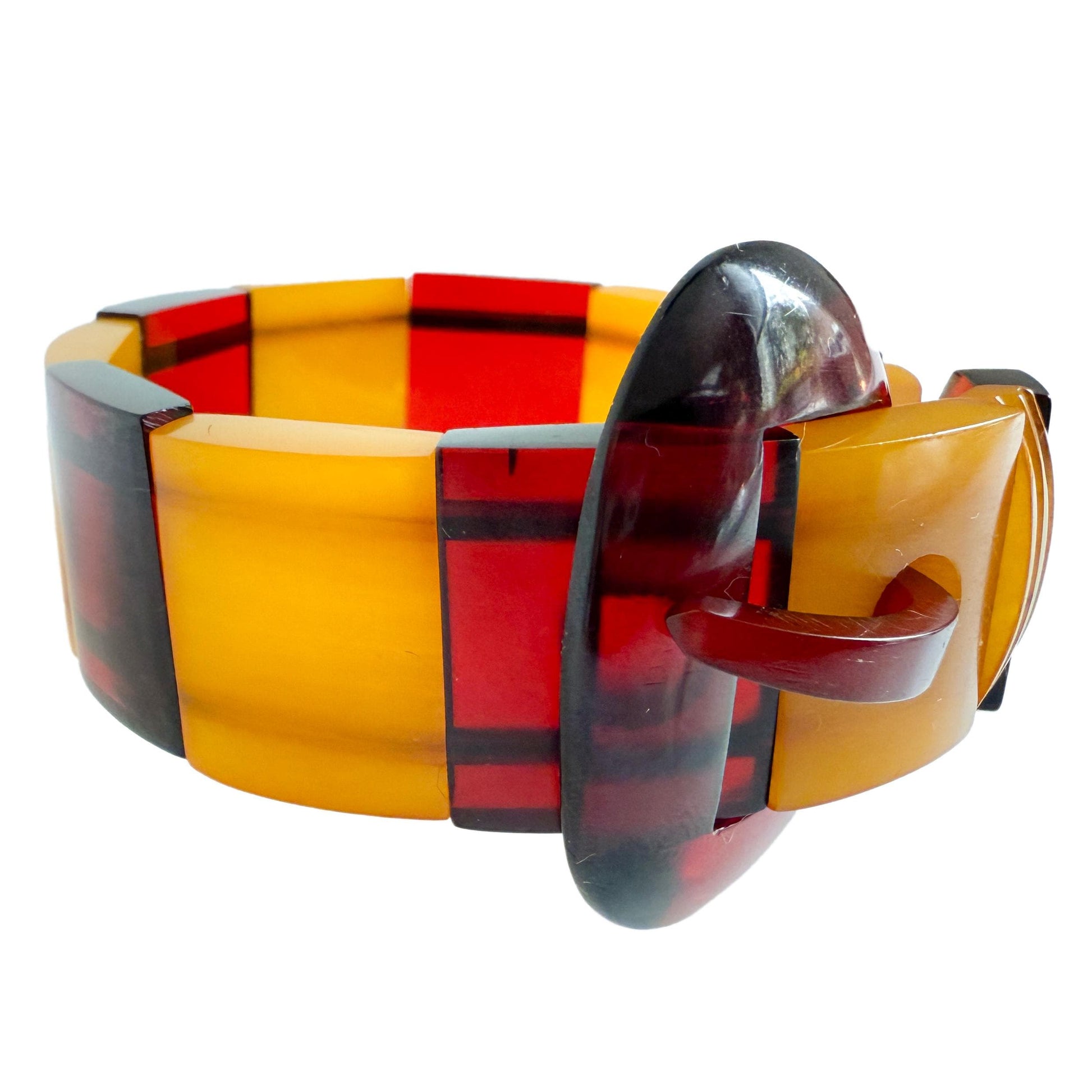 Art Deco Bakelite Catalin panel bracelet, 1940s. Cherry juice red and butterscotch bracelet with hand-carved clasp.