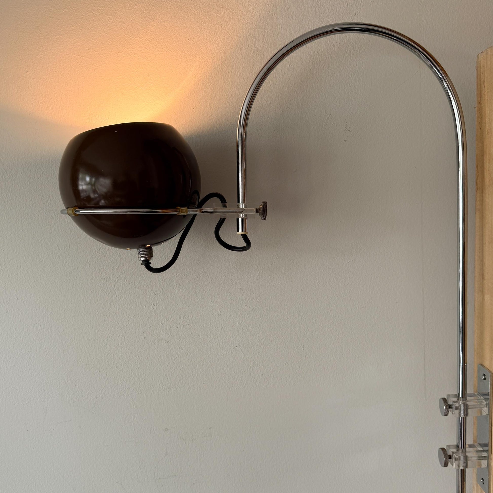 Space Age mushroom arc wall lamp with brown spherical shade and chrome arched arm attributed to Gepo.