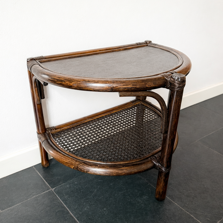 Mid-century bohemian rattan and cane half-moon wall table with woven cane shelf.