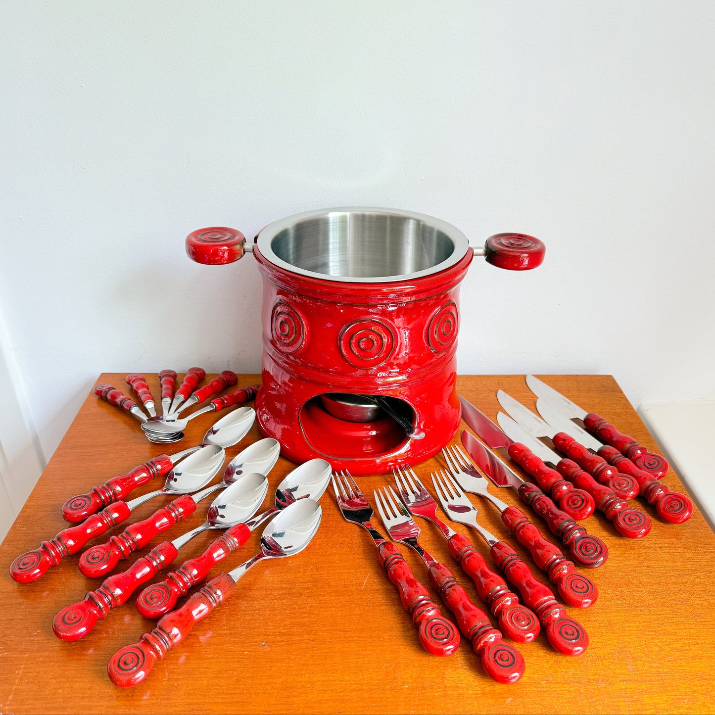 Mid-century style Wilkens Tirol cutlery set with red ceramic handles and matching fondue pot, Germany.