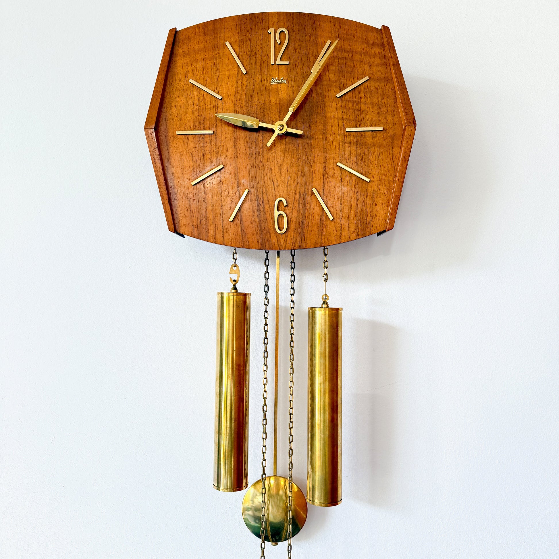 Mid-Century pendulum wall clock by Wuba with teak wood case and brass pendulum.