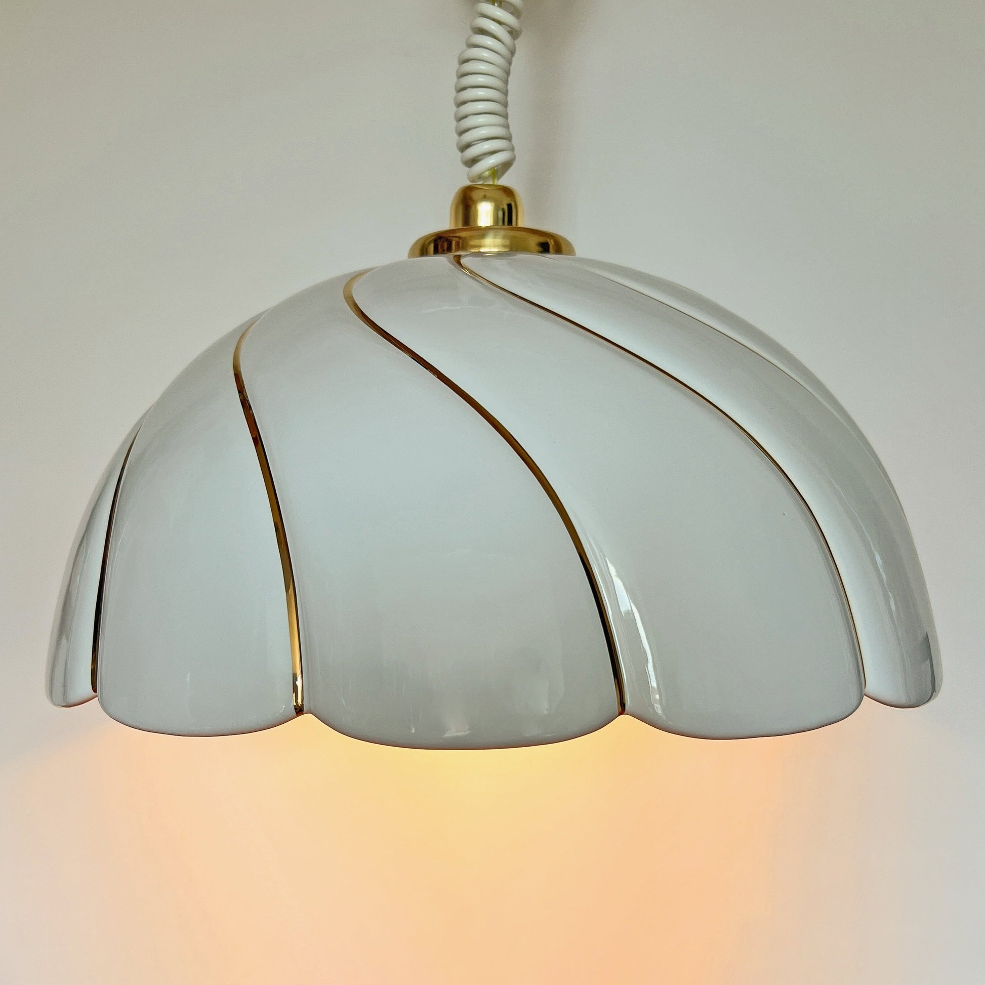 Vintage sculptural ceramic pendant lamp attributed to Tommaso Barbi with white glazed shade and gold brushstrokes.