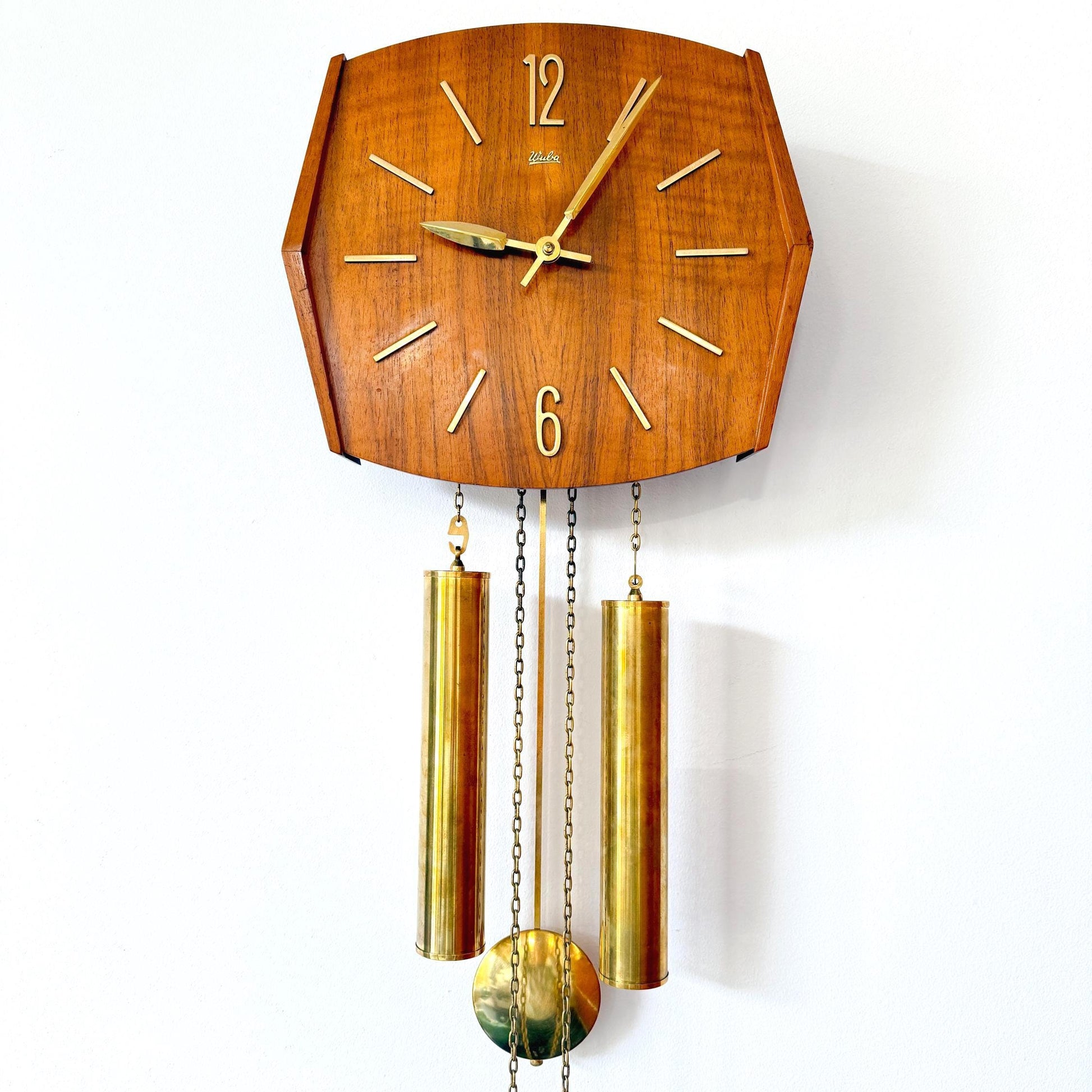 Mid-Century pendulum wall clock by Wuba with teak wood case and brass pendulum.