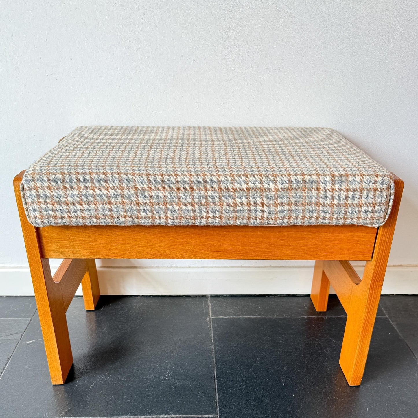 Mid-Century Modern Scandinavian wood and wool footstool circa 1970s with houndstooth upholstery.
